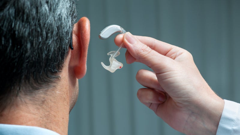 C:\Users\PC\Downloads\man_being_fitted_with_receiver_in_the_ear_hearing_aid.jpeg